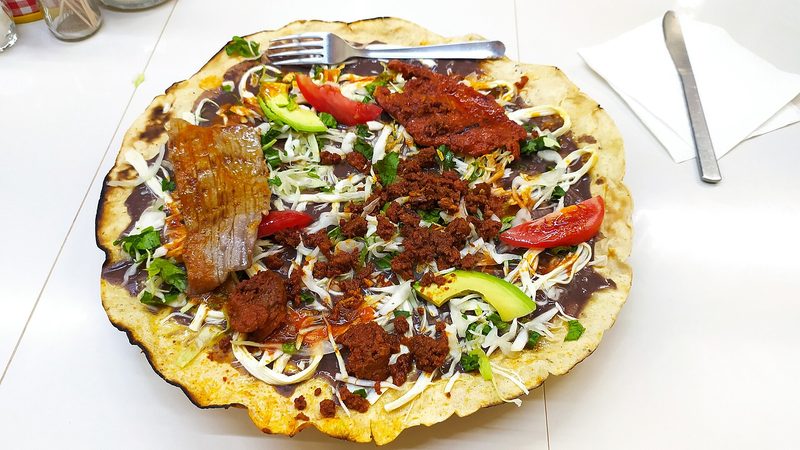 A tlayuda with tasajo and chorizo, a dish from Oaxaca